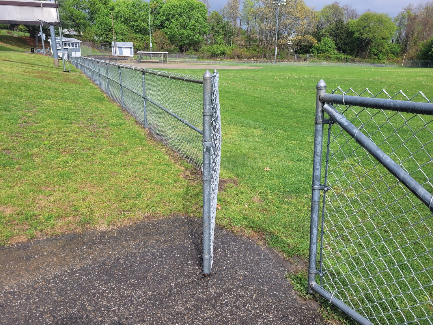 OPEN FOR PLAY? Johnston has been locking most of the town’s ballfields. One town councilman would like to see that policy change. The town’s director of buildings and grounds, however, says the locks keep out pooping dogs and their irresponsible owners. This War Memorial Park field was unlocked on Tuesday's rainy afternoon.